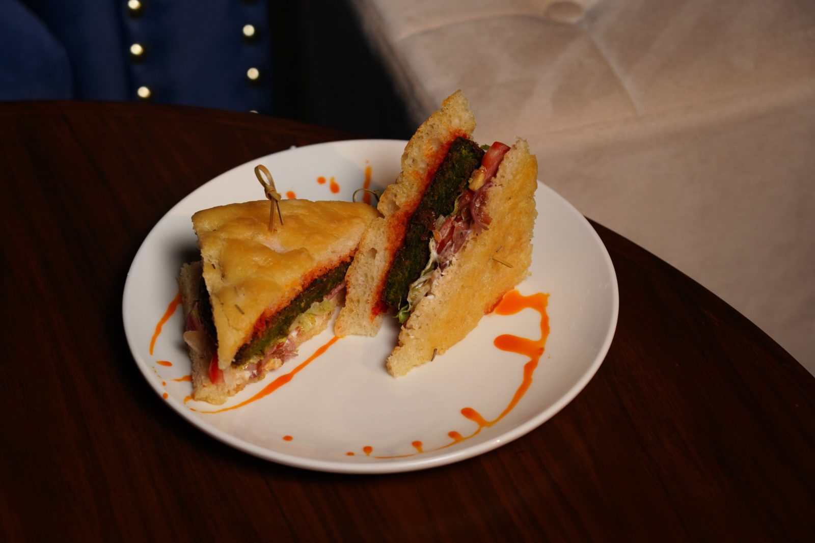 Focaccia sando with a green patty