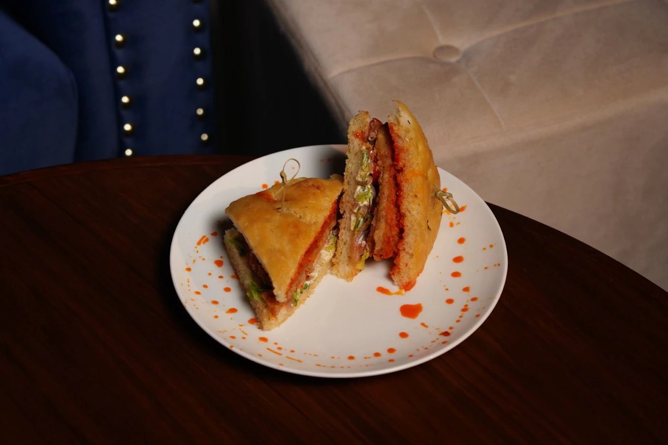 Grilled focaccia sando cut in half on a white plate at Big Daddy Creamery and Cafe